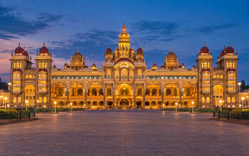 Illuminated Mysore Palace across its grand forecourt