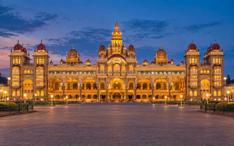 Illuminated Mysore Palace across its grand forecourt